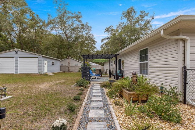 view of yard with a pergola, a patio, a garage, and an outdoor structure