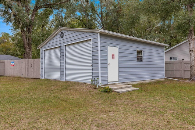 garage featuring a lawn