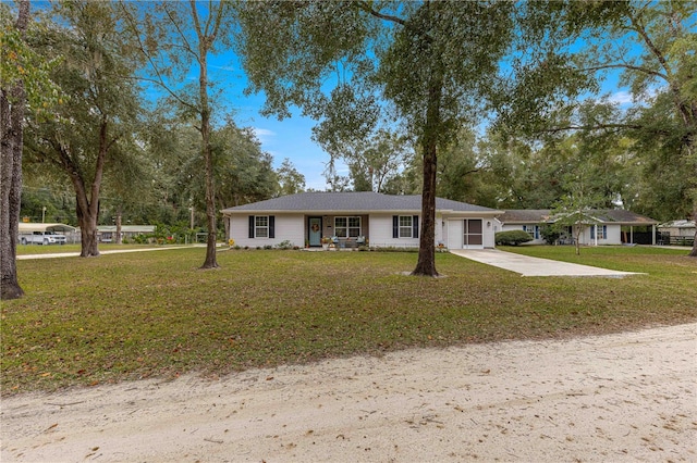 ranch-style home with a garage and a front lawn