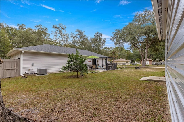 view of yard with a fenced backyard, a patio, and central air condition unit