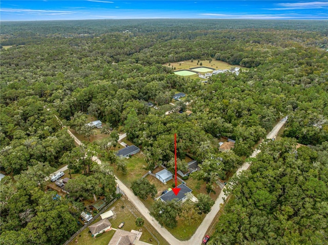 drone / aerial view featuring a wooded view