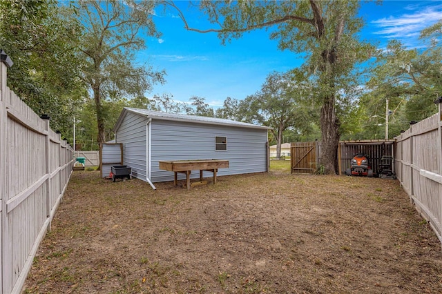 back of house featuring metal roof and a fenced backyard