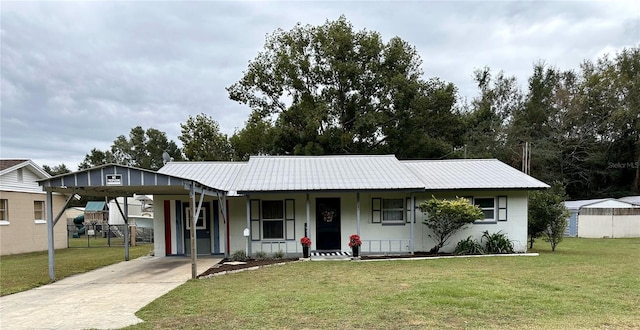 ranch-style house featuring a front yard, a carport, and covered porch