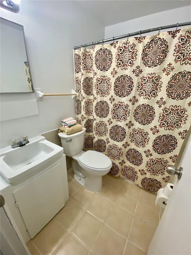 bathroom featuring tile patterned flooring, vanity, and toilet