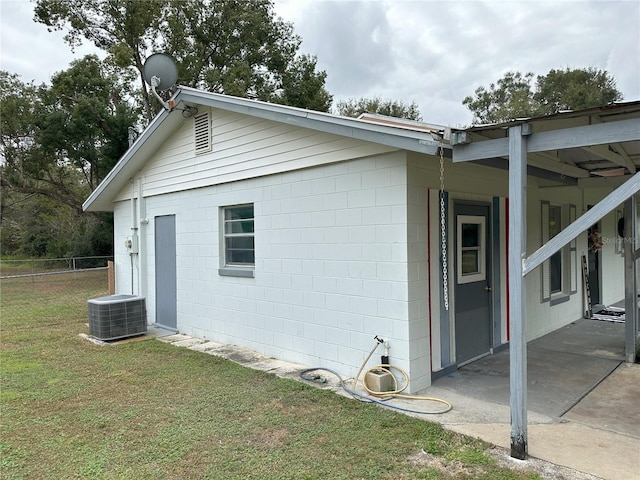 view of home's exterior with a yard and central AC unit