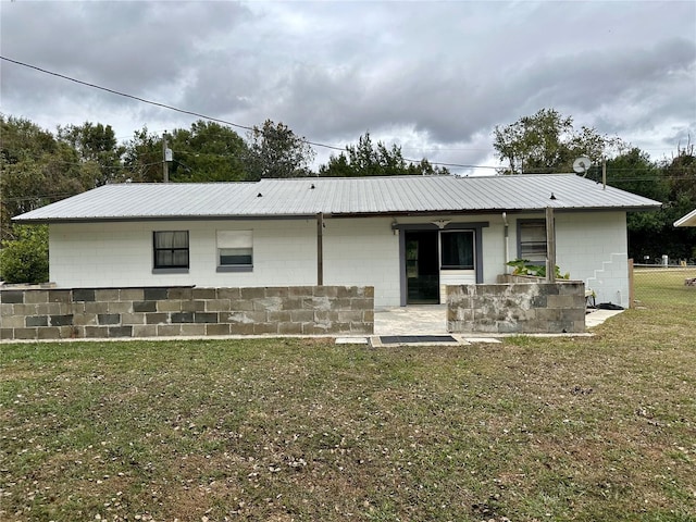 rear view of property featuring a yard