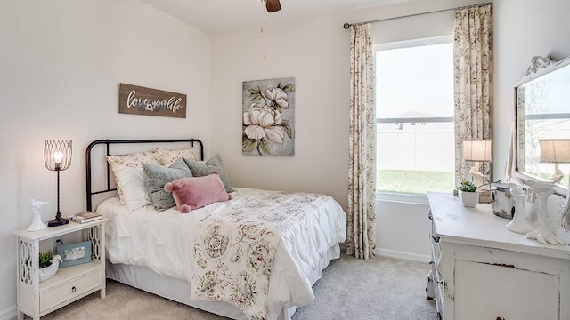 carpeted bedroom with multiple windows and ceiling fan