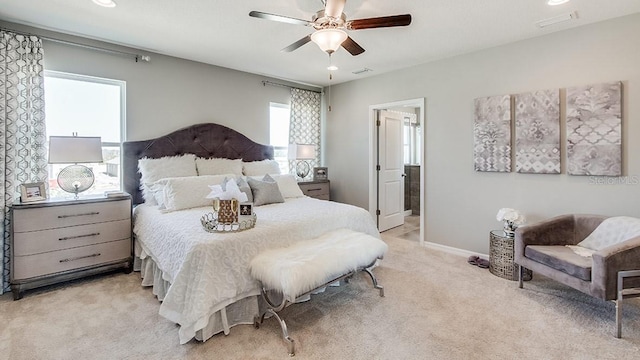 carpeted bedroom featuring ceiling fan and multiple windows