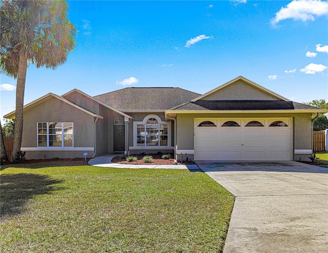 ranch-style house featuring a garage and a front lawn