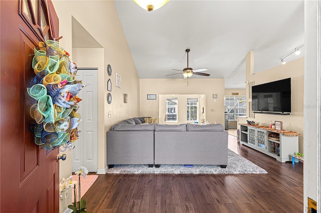 living room featuring lofted ceiling, dark wood-type flooring, and ceiling fan