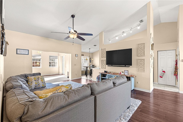 living room featuring dark hardwood / wood-style floors, ceiling fan, and lofted ceiling