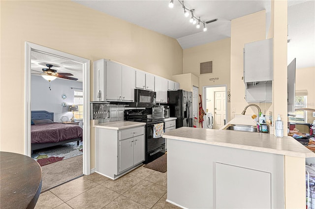 kitchen featuring black appliances, sink, ceiling fan, light tile patterned floors, and white cabinetry