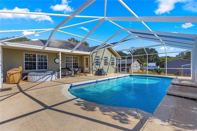 view of swimming pool featuring a patio area and a lanai