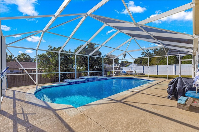 view of pool with a hot tub, a patio area, and a lanai