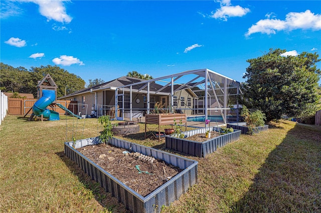 view of yard featuring a playground and glass enclosure