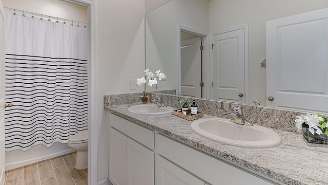 bathroom featuring hardwood / wood-style floors, vanity, and toilet