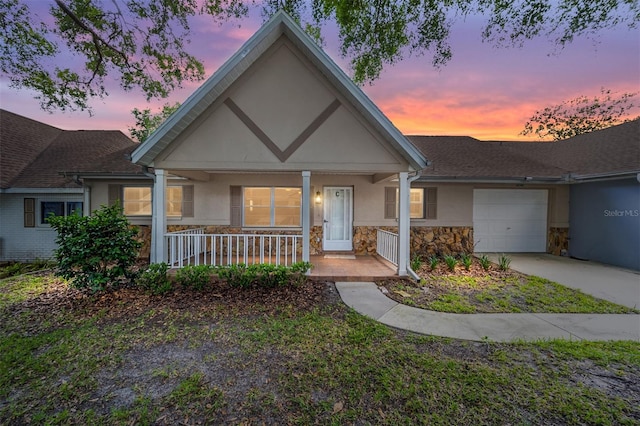 view of front of home with covered porch and a garage