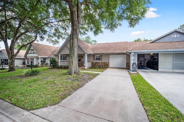 ranch-style home featuring a front lawn, covered porch, and a garage