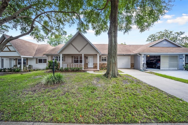 ranch-style house featuring a front yard, a porch, and a garage