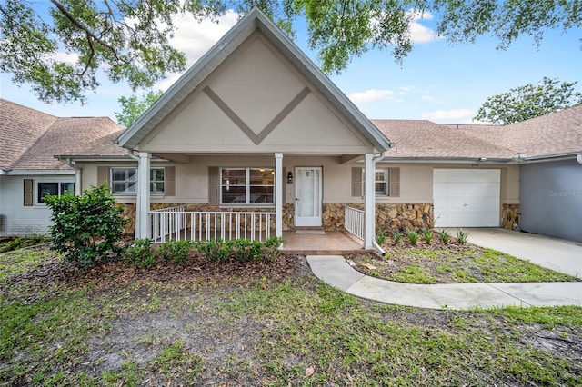 view of front of home with covered porch and a garage