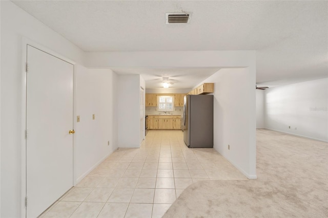 interior space featuring ceiling fan, sink, and a textured ceiling