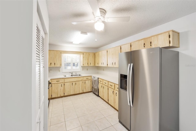 kitchen featuring light brown cabinets, sink, stainless steel appliances, a textured ceiling, and light tile patterned floors