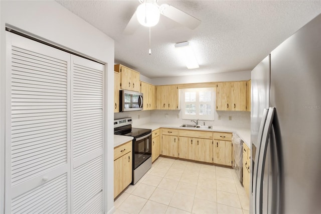 kitchen featuring light brown cabinets, sink, ceiling fan, a textured ceiling, and stainless steel appliances