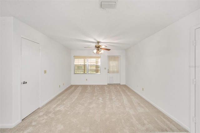 spare room featuring ceiling fan and light carpet