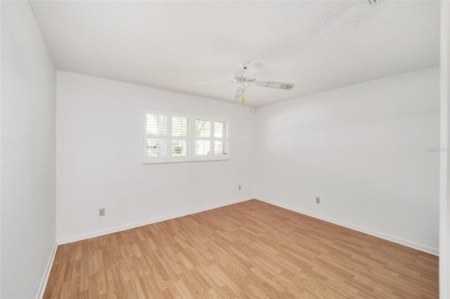 spare room with ceiling fan, a textured ceiling, and light hardwood / wood-style flooring