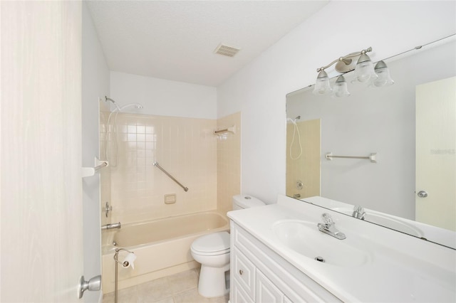 full bathroom featuring a textured ceiling, vanity, tile patterned flooring, toilet, and tiled shower / bath