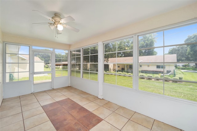 unfurnished sunroom with ceiling fan