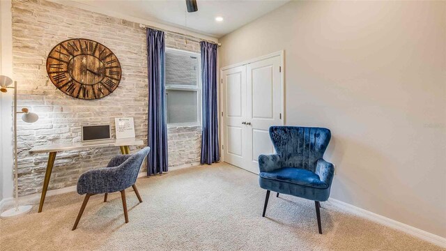 office area featuring carpet floors, a ceiling fan, and baseboards