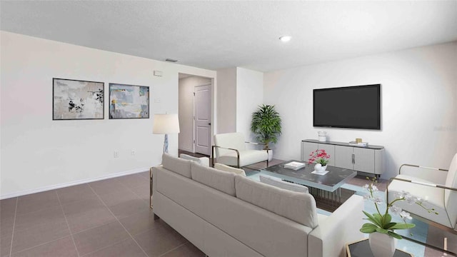 tiled living room featuring a textured ceiling