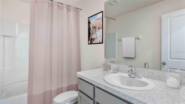 full bathroom with toilet, vanity, and shower / tub combo with curtain