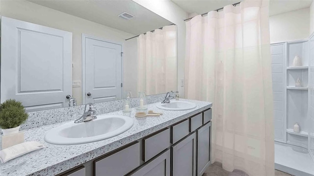 bathroom with curtained shower and vanity