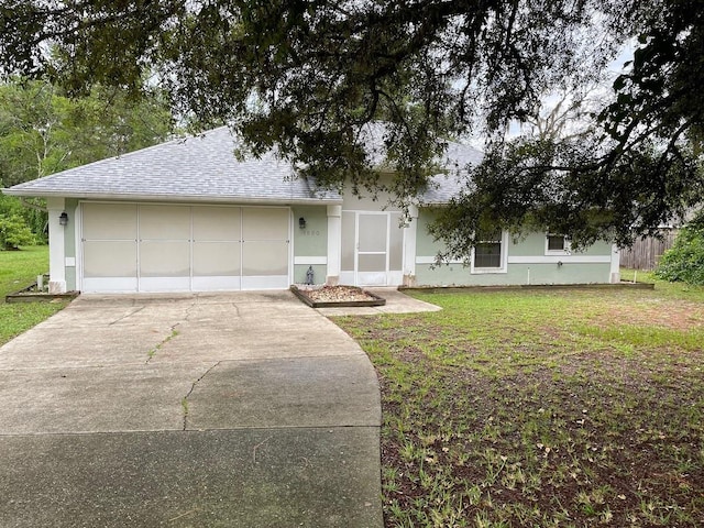 ranch-style home with a front lawn and a garage