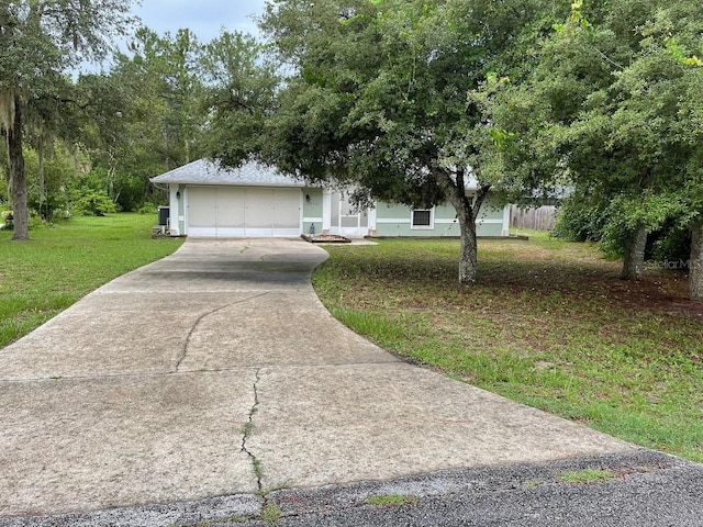 view of front of house featuring a front yard and a garage