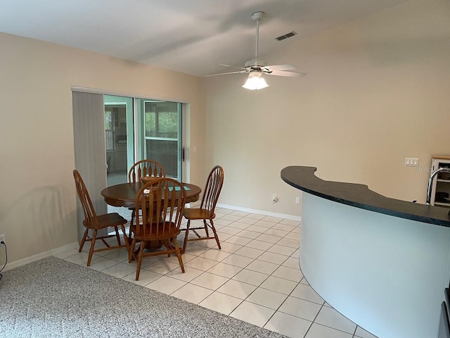 tiled dining room with ceiling fan