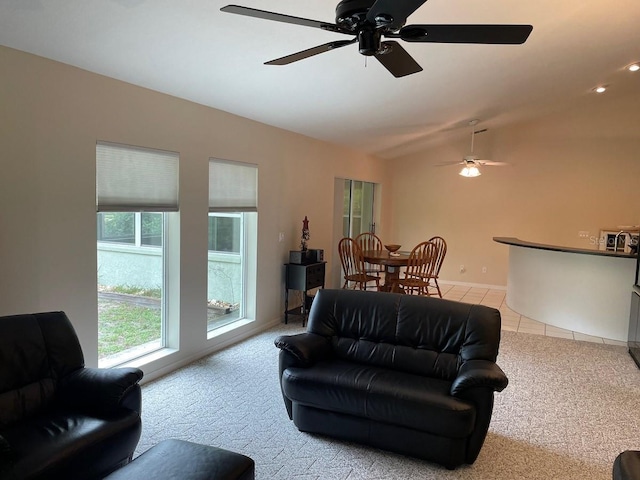 tiled living room featuring ceiling fan and vaulted ceiling