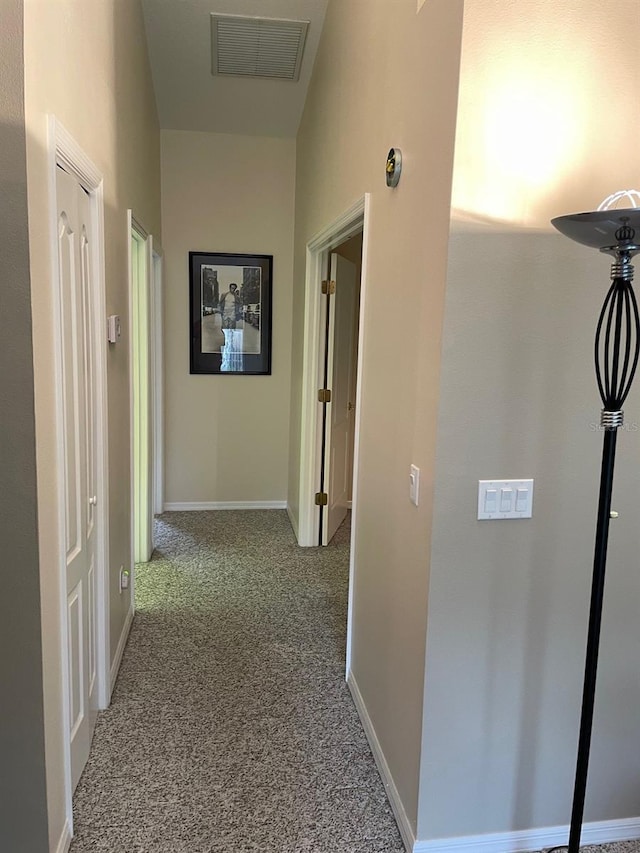 hallway featuring light carpet