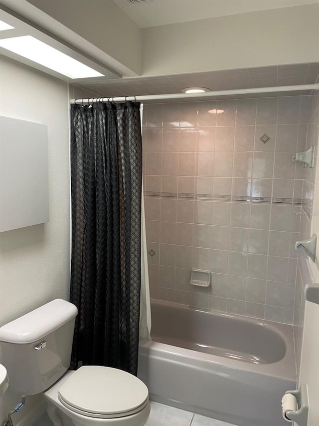 bathroom featuring tile patterned flooring, shower / bath combo, and toilet