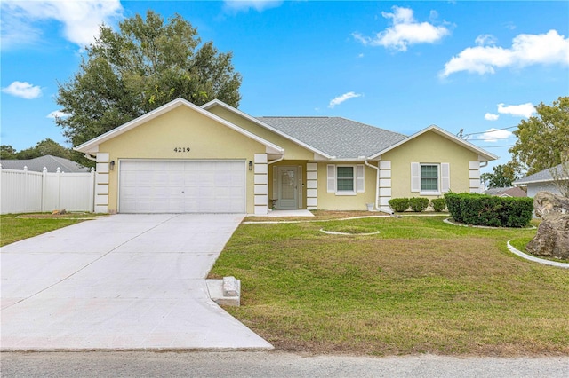 single story home featuring a garage and a front lawn