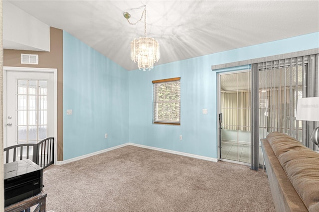 unfurnished room with carpet and an inviting chandelier