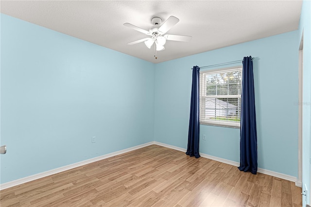 empty room featuring ceiling fan, a textured ceiling, and light wood-type flooring