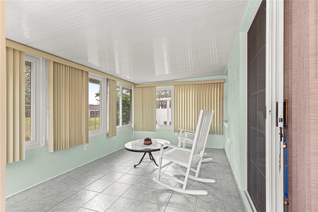 unfurnished sunroom featuring tile patterned flooring
