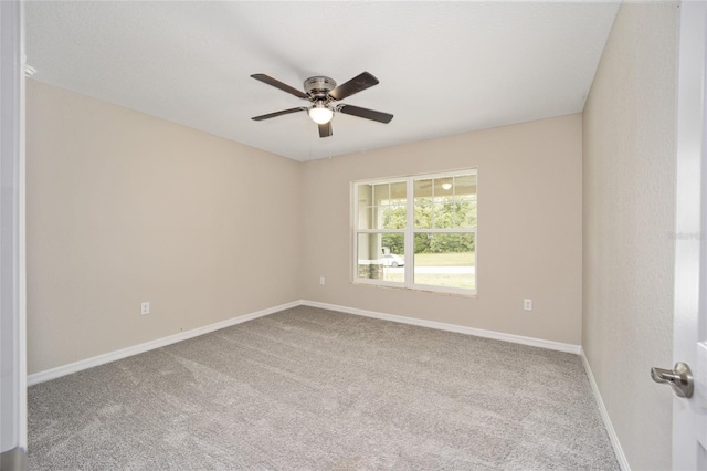 empty room with carpet flooring and ceiling fan