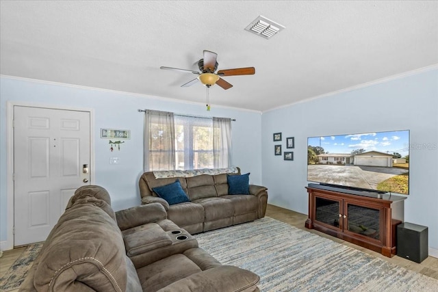 living room featuring light hardwood / wood-style floors, ceiling fan, and crown molding