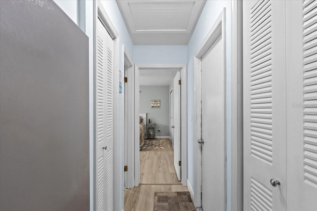 hallway with light hardwood / wood-style flooring