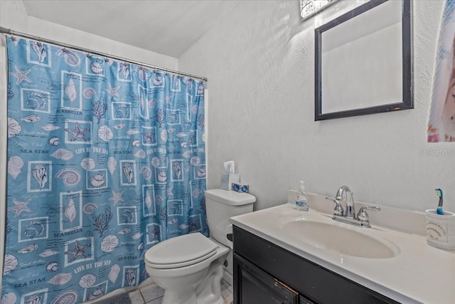 bathroom featuring tile patterned floors, a shower with curtain, vanity, and toilet