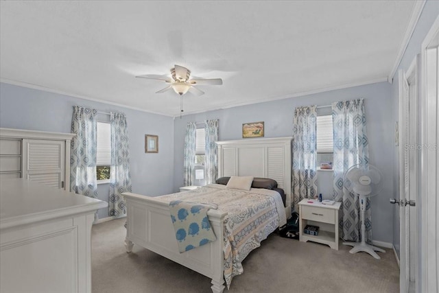 carpeted bedroom with multiple windows, ceiling fan, and crown molding